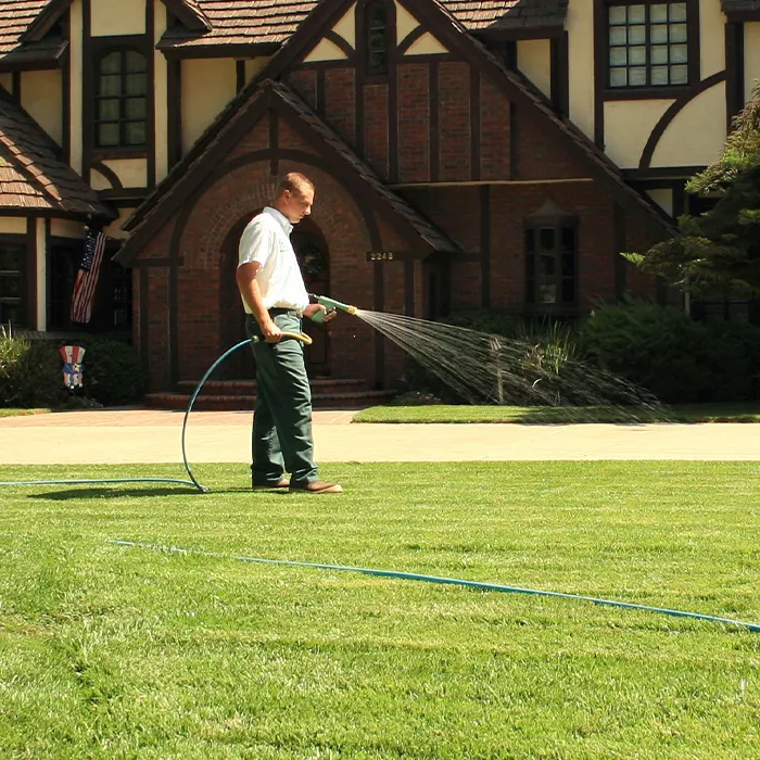 Lawnscape Systems technician watering a lawn